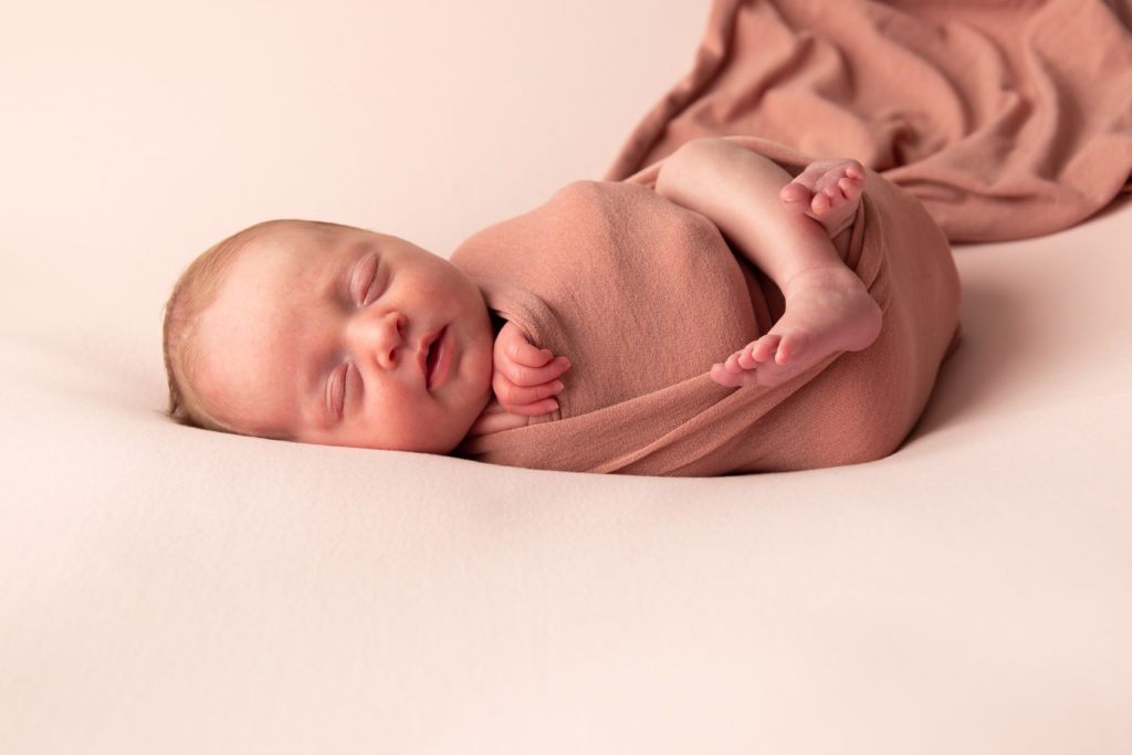 Séance photo nouveau né fille en studio dans l’Oise positionnée sur une couverture